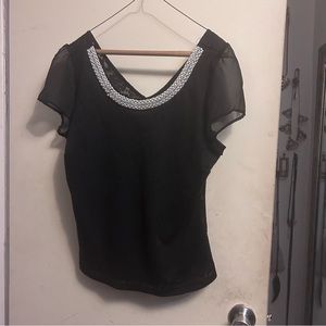 Blouse adorned with beads on the front collar